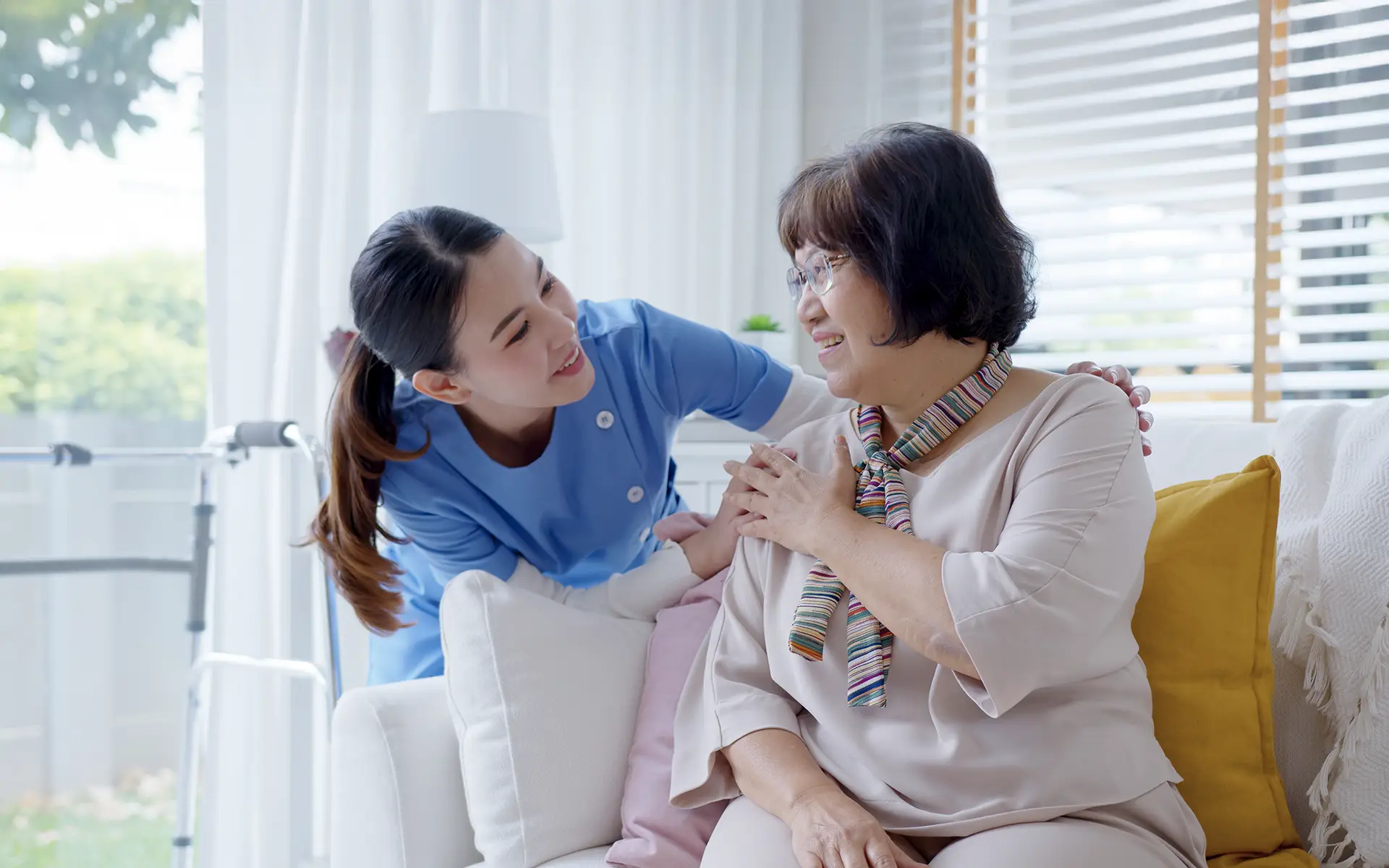 A care provider helping a senior woman.